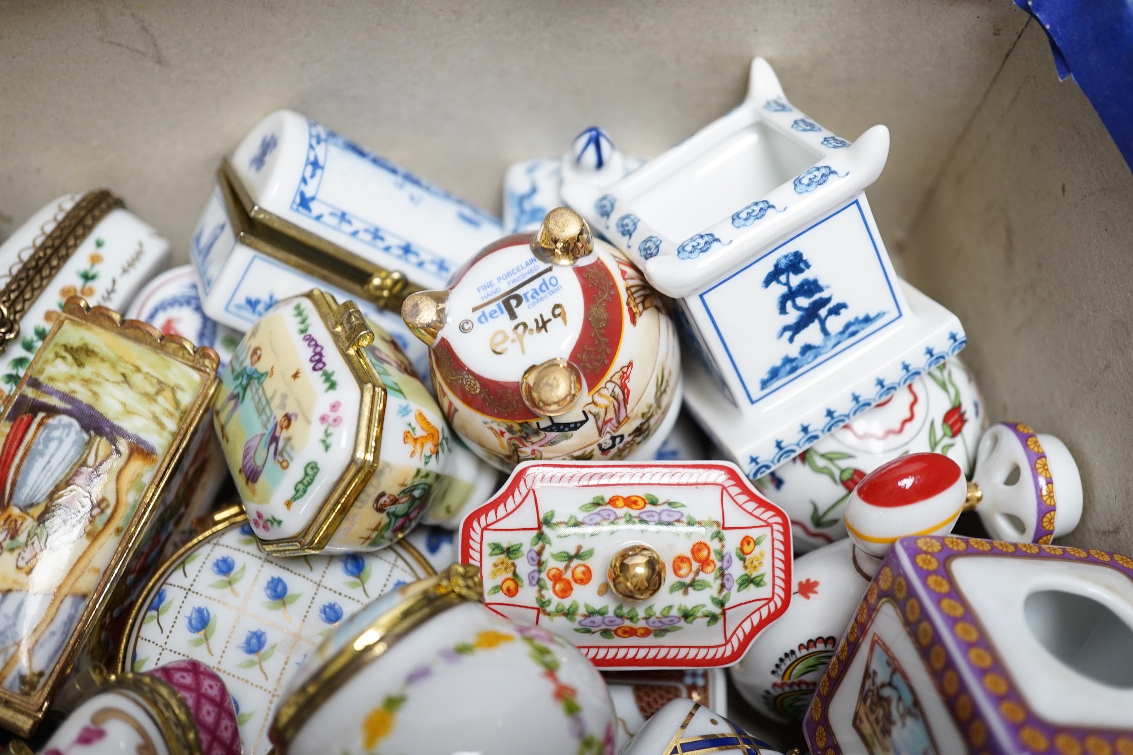 A quantity of approximately sixty Del Prado oriental and classic collection porcelain boxes, together with accompanying book and ephemera